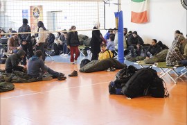 Migrants are seen at a first aid center set up at the Gallipoli fitness center, on December 31, 2014, after arriving in Italy aboard the Moldovan-flagged ship Blue SKy M. in the port of Gallipoli, in southeastern of Italy. Some 700 illegal migrants rescued from the ship near the Greek island of Corfu arrived in Italy on December 31 after their boat was intercepted while drifting towards the coast. Police and maritime authorities will investigate how the migrants, reportedly mainly from Syria, came to be hidden on the Blue Sky M as it sailed to the Croatian port of Rijeka. AFP PHOTO / NUNZIO GIOVE