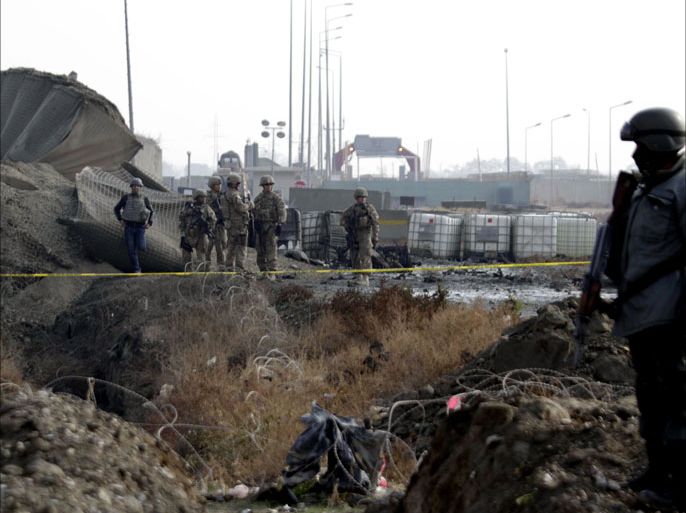 afghan and NATO's soldiers of International Security Assistance Force (ISAF) inspect the scene of a suicide bomb blast targeting a German troop convoy in Kabul, Afghanistan, 11 December 2013. An explosives-filled vehicle targeting a German troop convoy detonated on 11 December morning in Kabul but caused no casualties, the NATO-led International Security Assistance Force (ISAF) said. According to ISAF officials "the target of this morning suicide bombing was German troops as the suicide bomber blew himself up near a German soldiers’ convoy in front of Kabul airport." EPA/S. SABAWOON