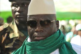(FILES)-- A file photo taken on November 22, 2011 shows Gambian President Yahya Jammeh greets supporters during a rally in Gambia. A military coup bid in the small west African state of The Gambia was foiled early on December 30, 2014, while President Yahya Jammeh was abroad, military and diplomatic sources said. "Members of the Gambian armed forces have been involved in serious (gunfire) around 3:00 am. They wanted to overthrow the regime," a military source said, while a Western diplomat said that presidential guard troops were among forces who attacked Jammeh's palace. AFP PHOTO / SEYLLOU