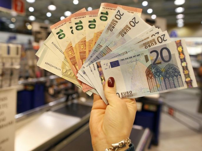 Euro bills are displayed by a salesperson in a shop in Vilnius, Lithuania, Thursday, Jan. 1, 2015. The Baltic state of Lithuania early Thursday became the 19th European Union member to adopt the joint European currency, the euro. (AP Photo/Mindaugas Kulbis)