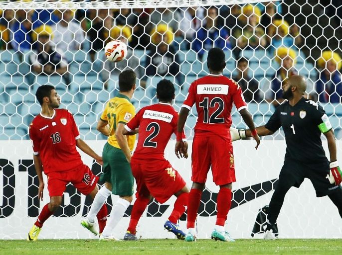 SYDNEY, AUSTRALIA - JANUARY 13: Matt McKay (2nd L) of Australia scores the opening goal during the 2015 Asian Cup match between Oman and Australia at ANZ Stadium on January 13, 2015 in Sydney, Australia.