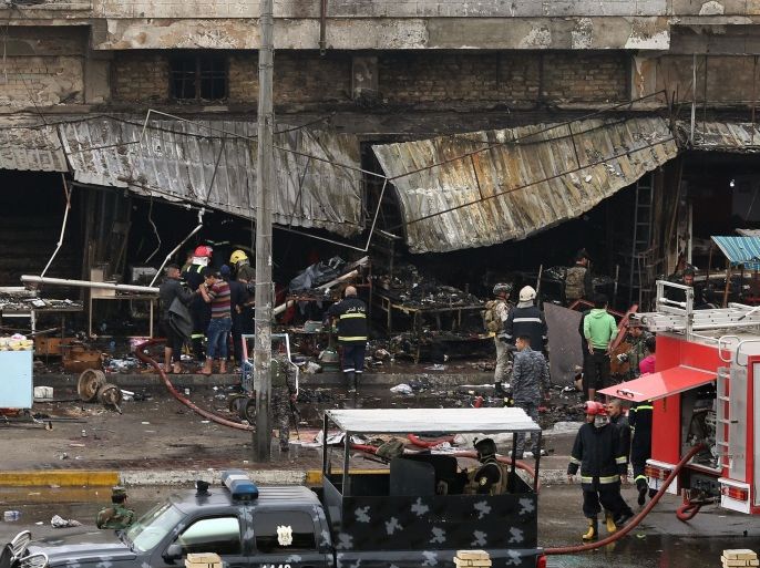 Security forces inspect the site of a twin bombing at a crowded market in Baghdad Iraq, Friday, Jan. 30, 2015. Police officials say the Friday morning attack started with a bomb exploding near carts selling used clothes in the city's central Bab al-Sharqi area. The second explosion, caused by a car bomb, went off two minutes later targeting people who rushed to help the victims from the first blast, killed and wounded more than a dozen of people, Iraqi officials said. (AP Photo/Hadi Mizban)