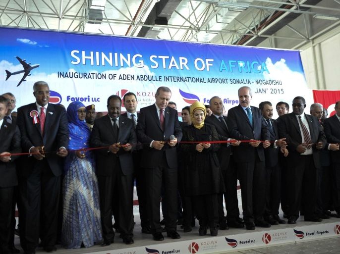 Turkey's President Recep Tayyip Erdogan (5th L) and Somalia's President Hassan Sheikh Mohamud (4th L) open the new terminal of Aden Abdulle International Airport in Mogadishu, January 25, 2015 in this handout photograph from the African Union Mission in Somalia (AMISOM). REUTERS/AMISOM Photo/Ilyas Ahmed/Handout via Reuters (SOMALIA - Tags: POLITICS TRANSPORT BUSINESS) ATTENTION EDITORS - THIS PICTURE WAS PROVIDED BY A THIRD PARTY. REUTERS IS UNABLE TO INDEPENDENTLY VERIFY THE AUTHENTICITY, CONTENT, LOCATION OR DATE OF THIS IMAGE. FOR EDITORIAL USE ONLY. NOT FOR SALE FOR MARKETING OR ADVERTISING CAMPAIGNS. THIS PICTURE IS DISTRIBUTED EXACTLY AS RECEIVED BY REUTERS, AS A SERVICE TO CLIENTS. NO SALES. NO ARCHIVES