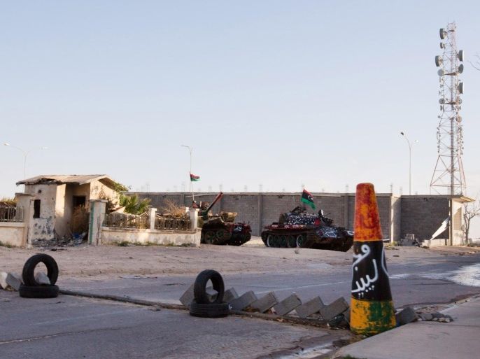 In this Wednesday, Feb. 18, 2015 photo, military tanks are seen outside the broadcast station in Sirte, Libya. (AP Photo/Mohamed Ben Khalifa)