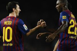 BARCELONA, SPAIN - OCTOBER 29: Lionel Messi of FC Barcelona (L) celebrates with his teammate Eric Abidal of FC Barcelona after scoring his third team's goal during the La Lliga match between FC Barcelona and RCD mallorca at Camp Nou on October 29, 2011 in Barcelona, Spain.