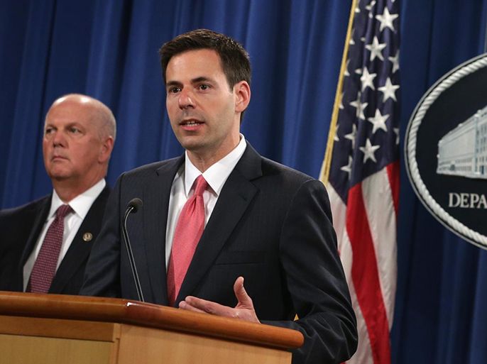 WASHINGTON, DC - MAY 19: Assistant U.S. Attorney General for National Security John Carlin (2ndL) speaks as Attorney General Eric Holder (R), and U.S. Attorney for Western District of Pennsylvania David Hickton (L) listen during an announcement on indictments against Chinese military hackers on cyber-espionage May 19, 2014 at the Department of Justice in Washington, DC. A grand jury in the Western District of Pennsylvania have indicted five Chinese military hackers for computer hacking, economic espionage and other offense directed at six American victim in the U.S. nuclear power, metals and solar products industries.