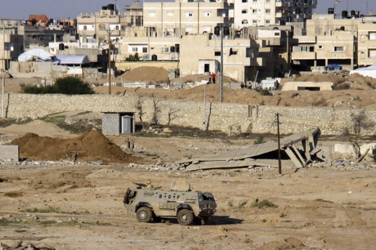 FILE - In this Nov. 6, 2014 file photo, an Egyptian army armored vehicle stands on the on the Egyptian side of border town of Rafah, north Sinai, Egypt. An Egyptian militant group affiliated with the Islamic State has claimed responsibility for coordinated and simultaneous attacks Thursday, Jan. 29, 2015 that struck more than a dozen army and police targets in three towns in the restive Sinai Peninsula, killing at least 26 security officers. Following the attack, el-Sissi cut short a trip to Ethiopia, to return to Cairo, MENA reported Friday.(AP Photo/Ahmed Abd El Latif, El Shorouk Newspaper, File) EGYPT OUT