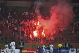 Soccer fans hold lit flares at the stand as they watch a match between Egyptian Premier League clubs Zamalek and ENPPI at Air Defense Stadium in a suburb east of Cairo, Egypt, Sunday, Feb. 8, 2015. A riot broke out Sunday night outside of the major soccer game, with a stampede and fighting between police and fans killing at least 22 people, authorities said. (AP Photo/Ahmed Abd El-Gwad, El Shorouk newspaper) EGYPT OUT