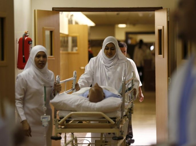 Nurses wheel a patient in the emergency department at Al-Noor Specialist Hospital in Mecca September 30, 2014. According to hospital director Dr. Mohammad bin Omar, the hospital did not record any cases of pilgrims bearing the MERS coronavirus or Ebola virus entering Mecca for the Haj season, and that most of the cases referred to the hospital were of elderly patients with common ailments. REUTERS/ Muhammad Hamed (SAUDI ARABIA - Tags: RELIGION HEALTH)