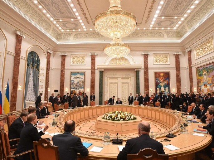 Russian President Vladimir Putin, German Chancellor Angela Merkel, Ukrainian President Petro Poroshenko and French President Francois Hollande attend a meeting in Minsk, Belarus, Wednesday, Feb. 11, 2015. Leaders of Russia, Ukraine, France and Germany are gathering for crucial talks in the hope of negotiating an end fighting between Russia-backed separatist and government forces in eastern Ukraine. (AP Photo/Kirill Kudryavtsev, Pool)
