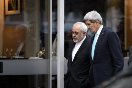 US Secretary of State John Kerry, right, speaks with Iranian Foreign Minister Mohammad Javad Zarif, as they walk in the city of Geneva, Switzerland, Wednesday, Jan. 14, 2015, during a bilateral meeting ahead of the next round of nuclear discussion. (AP Photo/Keystone,Martial Trezzini)