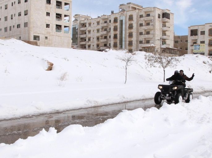 AMMAN, JORDAN - FEBRUARY 20: Jordanians on a quad bike seen in Amman capital of Jordan, on February 20, 2015 after snowfall hit the region.