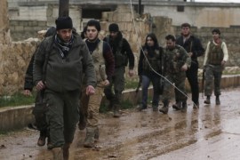 Rebel fighters carry their weapons as they walk in Ratian village, north of Aleppo, after what they said was an offensive against them by forces loyal to Syria's President Bashar al-Assad who attempted to advance in the village but failed to, February 18, 2015. Battles in and around the Syrian city of Aleppo have killed at least 70 pro-government fighters and more than 80 insurgents after the army launched an offensive there, a monitoring group said on Wednesday.The army backed by allied militia had captured areas north of Aleppo on Tuesday in what the Syrian Observatory for Human Rights said was an attempt to encircle the northern city and cut off insurgent supply lines. REUTERS/Hosam Katan (SYRIA - Tags: POLITICS CIVIL UNREST CONFLICT)