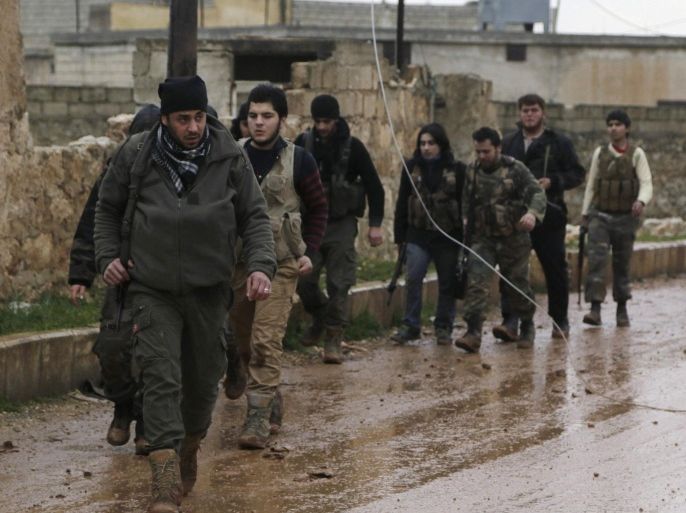 Rebel fighters carry their weapons as they walk in Ratian village, north of Aleppo, after what they said was an offensive against them by forces loyal to Syria's President Bashar al-Assad who attempted to advance in the village but failed to, February 18, 2015. Battles in and around the Syrian city of Aleppo have killed at least 70 pro-government fighters and more than 80 insurgents after the army launched an offensive there, a monitoring group said on Wednesday.The army backed by allied militia had captured areas north of Aleppo on Tuesday in what the Syrian Observatory for Human Rights said was an attempt to encircle the northern city and cut off insurgent supply lines. REUTERS/Hosam Katan (SYRIA - Tags: POLITICS CIVIL UNREST CONFLICT)