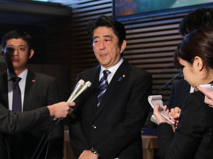 Japanese Prime Minister Shinzo Abe is surrounded by press after a ministerial meeting on an online video showing purportedly Japanese hostage killed by the Islamic State, at his official residence in Tokyo on February 1, 2015. Japan said it was 'outraged' after the Islamic State group released a video purportedly showing the beheading of Japanese hostage Kenji Goto. AFP PHOTO / Yoshikazu TSUNO