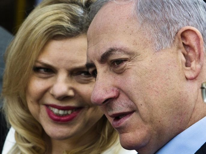Israeli Prime Minister Benjamin Netanyahu and his wife Sara (L) attend a reinterment ceremony in the agricultural cooperative of Avihayil, north of Netanya in this December 4, 2014 file photo. The latest political fracas in Israel is over whether the prime minister's wife kept the deposit when she recycled bottles from state functions. REUTERS/Nir Elias/Files (ISRAEL - Tags: POLITICS ELECTIONS)