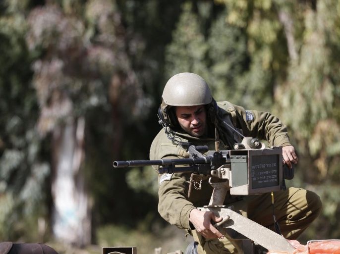 An Israeli soldier adjusts a weapon atop an armoured military ambulance near Israel's border with Lebanon January 28, 2015. At least 22 shells fired from Israel hit open farmland in southern Lebanon close to the frontier, a Lebanese security source in the area said on Wednesday. Earlier in the day an anti-tank missile was fired at an Israeli military vehicle near the frontier with Lebanon, an Israeli army spokesman said. REUTERS/Baz Ratner (ISRAEL - Tags: MILITARY POLITICS CIVIL UNREST)