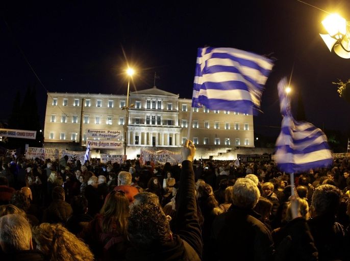 Protesters gather outside the parliament as they take part in a rally in solidarity with the Greek government for the negotiations with the country's international lenders, in Athens, Greece, 15 February 2015. Thousands of people gathered at Syntagma Square in central Athens in order to protest against EU-austerity policy while EU Finance ministers of the Eurogroup are going to meet on 16 February in Brussels, Belgium, for a discussion of the Greek situation.