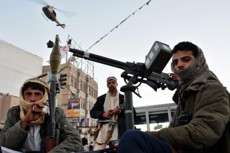 A Yemeni army helicopter patrols from the sky as heavily armed members of the Houthi militia stand watch over a rally commemorating the fourth anniversary of the 2011 uprising and celebrating the Houthis takeover in Sanaa, Yemen, 11 February 2015. Reports state thousands of Houthi supporters took to streets of Sanaa commemorating the 2011 protesters that led to the downfall of the regime of the former Yemeni President Ali Abdullah Saleh, while at the same time in other Yemeni cities many marched in protest of the Houthi takeover of Sana'a and other areas of the country.