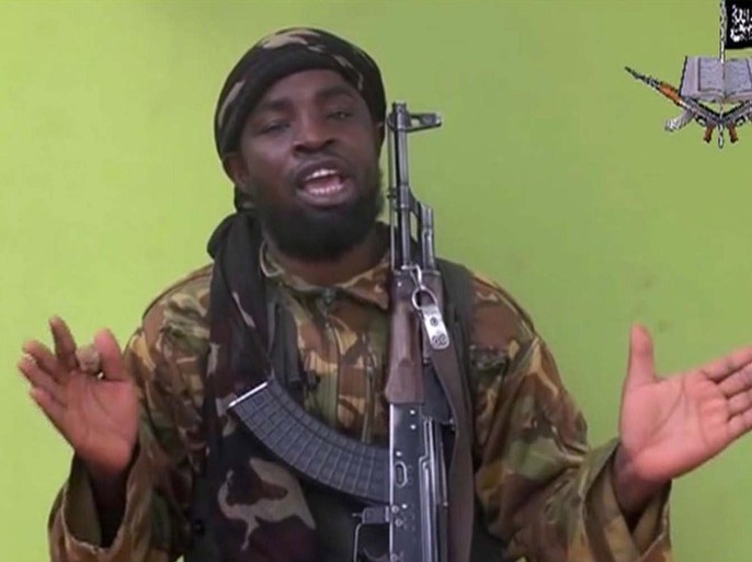 FILE -This is a Monday May 12, 2014 file photo taken from video by Nigeria's Boko Haram terrorist network, showing their leader Abubakar Shekau speaking to the camera. Suspected Boko Haram Islamic extremists attacked a Cameroonian military base near the border with Nigeria, killing at least five soldiers, an army colonel said Tuesday, Feb. 17, 2015. (AP Photo, File)
