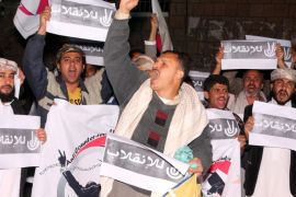 IBB, YEMEN - FEBRUARY 06: A group of people, including members of Yemen's Revolution Youth Council, hold banners and shout slogans during a demonstration against constitutional declaration issued by the Shiite Houthi movement that dissolves parliament and establishing a 551-member 'transitional council', in Ibb, Yemen on February 06, 2015.