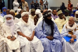 Members from the National Movement for the Liberation of Azawad (MNLA) attend the opening of peace talks on September 1, 2014 in Algiers between the Malian government and armed rebels, which are the second round of negotiations since July aimed at clinching a lasting peace agreement. The Bamako government and six rebel groups, mostly Tuareg but also including Arab organisations, are seeking to resolve a decades-old conflict that created a power vacuum in the desert north that was exploited by Al-Qaeda. AFP PHOTO / FAROUK BATICHE