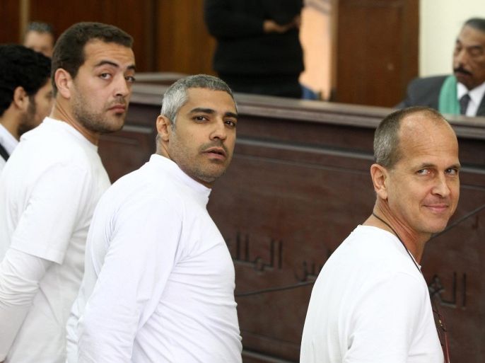 (FILE) A file photo dated 31 March 2014 shows Australian journalist Peter Greste (R), Canadian-Egyptian journalist Mohammed Fahmy (C) and journalist Baher Mahmoud (L) standing in front of the judge's bench during their trial for allegedly supporting a terrorist group and spreading false information, in Cairo, Egypt. An Egyptian court on 12 February 2015 ordered the release of two Al Jazeera journalists jailed for more than a year. Fahmy was ordered to pay a bail of 250,000 Egyptian pounds (around 32,890 dollars). His colleague Egyptian journalist Baher Mohammed was released without bail. Their release was ordered more than a week after Egyptian authorities released and deported Australian Peter Greste, one of the three journalists charged in the case.