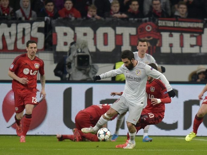 Atletico's Arda Turan, centre controls the ball during the Champions League round of 16 first leg soccer match between Bayer 04 Leverkusen and Atletico de Madrid on Wednesday, Feb. 25, 2015 in Leverkusen, Germany. (AP Photo/Martin Meissner)