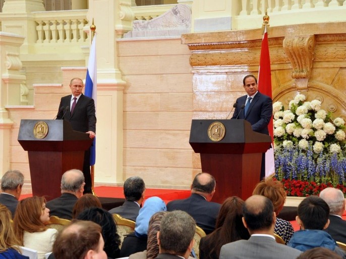 In this image released by the Egyptian Presidency, Egyptian President Abdel-Fattah el-Sissi, right, and Russian President Vladimir Putin, hold a press conference at the presidential palace in Cairo Egypt, Tuesday, Feb. 10, 2015. The presidents of Egypt and Russia on Tuesday said the two countries would build Egypt's first nuclear power plant together and boost natural gas trade and other ties. (AP Photo/Egyptian Presidency)