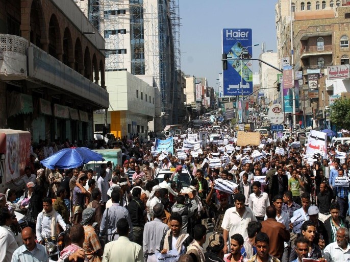TA'IZZ YEMEN - FEBRUARY 25: A group of people hold banners as they march during a demonstration against Shiite Houthi movement that interfere to the country's government, at Sanaa Street in Ta'izz, Yemen on February 25, 2015. Protesters chant slogans supporting Abd Rabbuh Mansur Hadi, forced to resign from presidency.