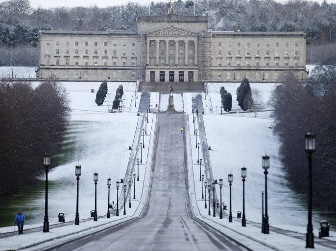 A walker braves the bitter weather at Stormont, Belfast, Northern Ireland, Thursday, Jan. 29, 2015. Heavy snow falls have swept across many parts of the UK and Ireland closing hundreds of schools and bringing traffic nightmares for motorists. (AP Photo/Peter Morrison)