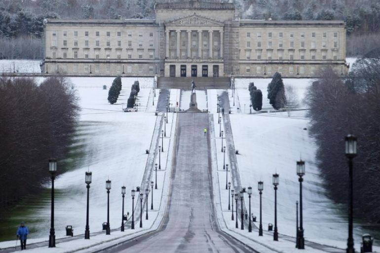 A walker braves the bitter weather at Stormont, Belfast, Northern Ireland, Thursday, Jan. 29, 2015. Heavy snow falls have swept across many parts of the UK and Ireland closing hundreds of schools and bringing traffic nightmares for motorists. (AP Photo/Peter Morrison)
