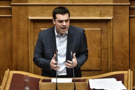Greek Premier Alexis Tsipras addresses the parliament during his policy speech in Athens on February 8, 2015. New Greek Prime Minister Alexis Tsipras said on February 8 that Greece did not want an extension of its bailout but a 'bridge programme' which would buy the country time to negotiate a new deal. AFP PHOTO / ARIS MESSINIS