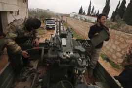 Rebel fighters work on an anti-aircraft weapon mounted on a pick-up truck after what they said was an offensive against them by forces loyal to Syria's President Bashar al-Assad that attempted to advance in the village but failed to, in Ratian, north of Aleppo February 18, 2015. Battles in and around the Syrian city of Aleppo have killed at least 70 pro-government fighters and more than 80 insurgents after the army launched an offensive there, a monitoring group said on Wednesday. Picture taken February 18, 2015. REUTERS/Ammar Abdullah (SYRIA - Tags: POLITICS CIVIL UNREST CONFLICT)