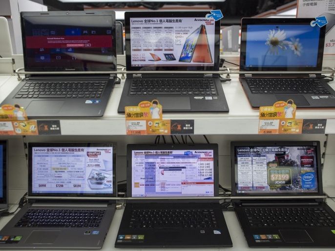 Lenovo Group Ltd. laptop computers are displayed on shelves in a Fortress electronics store, operated by A.S. Watson & Co., in the Tsim Sha Tsui district of Hong Kong, China, on Tuesday, March 25, 2014. Temasek Holdings Ptes plan to buy a stake in the retail arm of billionaire Li Ka-shings Hutchison Whampoa Ltd. will help the investment firm extend its reach in China and ease its reliance on Singapores banks.