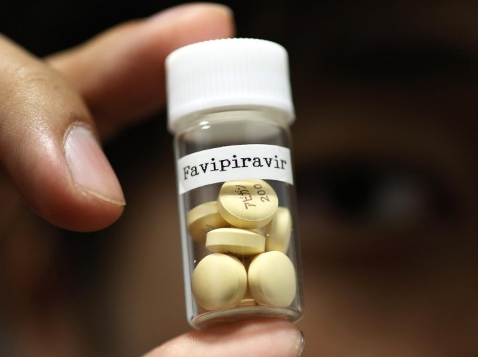 Tablets of Avigan (generic name : Favipiravir), a drug approved as an anti-influenza drug in Japan and developed by drug maker Toyama Chemical Co, a subsidiary of Fujifilm Holdings Co. are displayed during a photo opportunity at Fujifilm's headquarters in Tokyo October 22, 2014. Japan's Fujifilm Holdings Corp said on Monday it was expanding the production of its Avigan anti-influenza drug to reach an additional number of Ebola patients. France and Guinea plan to conduct clinical trials of Avigan 200 mg tablets, made by Fujifilm group company Toyama Chemical Co, in Guinea to treat Ebola in mid-November, Fujifilm said in a statement. REUTERS/Issei Kato (JAPAN - Tags: SCIENCE TECHNOLOGY HEALTH BUSINESS)