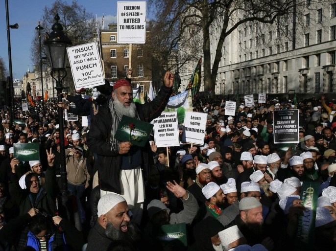 Muslim demonstrators hold placards during a protest against the publication of cartoons depicting the Prophet Mohammad in French satirical weekly Charlie Hebdo, near Downing Street in central London February 8, 2015. REUTERS/Stefan Wermuth (BRITAIN - Tags: POLITICS CIVIL UNREST RELIGION TPX IMAGES OF THE DAY)