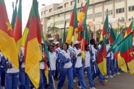 People wave Cameroon's national flag as they take part in a demonstration on February 28, 2015 in downtown Yaounde, against Islamist group Boko Haram and in support of the Cameroonian army engaged in a multi-national battle against the group. Some 10,000 to 15,000 people took part to the march. AFP PHOTO / REINNIER KAZE