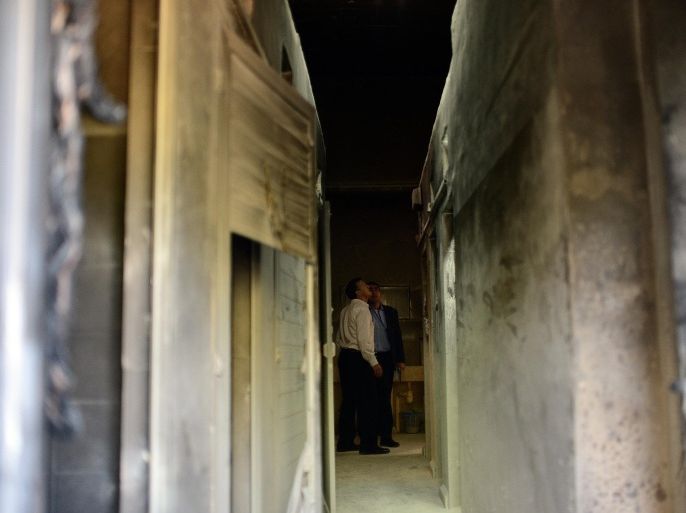 JERUSALEM, ISRAEL - FEBRUARY 26: Officers inspect damaged baths at the crime scene after a school of Greek Orthodox Church was set on fire by unidentified attackers in West Jerusalem, Israel on February 26, 2015. The fire has not caused any human casualties.