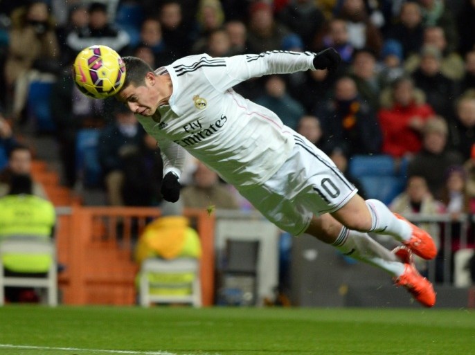 MADRID, SPAIN - FEBRUARY 04: James Rodriguez of Real Madrid scores their opening goal from a header during the La Liga match between Real Madrid CF and Sevilla FC at Estadio Santiago Bernabeu on February 4, 2015 in Madrid, Spain.