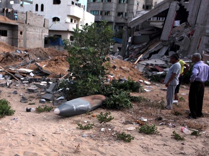 GAZA CITY, GAZA - JULY 14: Palestinians inspect unexploded air missile near a house destroyed in air attacks staged by Israel army within the scope of 'Operation Protective Edge' in Gaza City, Gaza on July 14, 2014. At least 172 people have been killed and around 1268 injured since the start of the Israeli military operation.