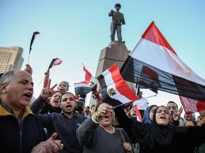 CAIRO, EGYPT - FEBRUARY 06: A group of Egyptians hold banners and posters as they gather at Abdul Munim Riyad Square during an anti-terrorism demonstration that demands giving authority to Abdel Fattah Sisi, in Cairo Egypt 06 February, 2015