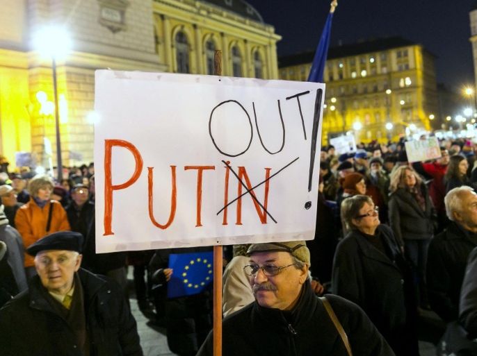 Followers of the Hungarian organization Human Platform gather in front of Keleti Railway Station as they protest against the visit of Russian President Vladimir Putin in Budapest, Hungary, Monday, Feb. 16, 2015, the eve of Putin’s one-day visit to Budapest. (AP Photo/MTI, Balazs Mohai)