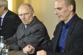 Greece's new Finance Minister Yanis Varoufakis (R) and his German counterpart Wolfgang Schaeuble (C) give a joint press conference with German Finance Ministry Spokesman Martin Jaeger (L) following their meeting on February 5, 2015 at the Finance ministry in Berlin. The new Greek finance minister's stop in Berlin follows a high-stakes visit to ECB headquarters in Frankfurt to try to drum up support for the new anti-austerity government's debt relief bid. AFP PHOTO / ODD ANDERSEN