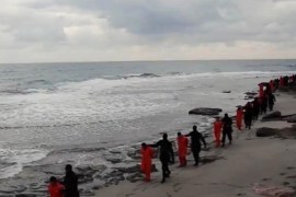 This image made from a video released Sunday Feb. 15, 2015 by militants in Libya claiming loyalty to the Islamic State group purportedly shows Egyptian Coptic Christians in orange jumpsuits being led along a beach, each accompanied by a masked militant. Later in the video, the men are made to kneel and one militant addresses the camera in English before the men are simultaneously beheaded. The Associated Press could not immediately independently verify the video. (AP Photo)