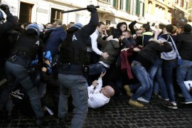 Italian policemen clash with Feyenoord's fans at the Spanish steps, in downtown Rome, prior to the Europa League soccer match between Roma and Feyenoord, Thursday, Feb. 19, 2015. (AP Photo/Gregorio Borgia)