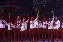 Players of Qatar's team celebrate during the award ceremony after winning second place of the 24th Men's Handball World Championship in Doha February 1, 2015. Handball heavyweights France clinched their fifth world title after versatile playmaker Nikola Karabatic steered them to a 25-22 win over host nation and surprise finalists Qatar in a hotly contested duel on Sunday. REUTERS/Mohammed Dabbous (QATAR - Tags: SPORT HANDBALL)