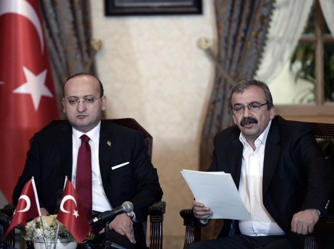 In this photo provided by the Turkish Prime Minister's Press Office, Pro-Kurdish legislator Sirri Sureyya Onder, right, and Turkey's deputy prime minister Yalcin Akdogan speak after a meeting in Istanbul, Turkey, Saturday, Feb. 28, 2015. Imprisoned Kurdish rebel leader Abdullah Ocalan has called on his fighters to lay down arms as part of a peace process to end a 30-year insurgency, Turkey's main Kurdish party said Saturday. Onder said Ocalan is asking his Kurdistan Workers' Party, or PKK, to hold an extraordinary congress in the spring to take the "historic decision" to end its armed struggle. There was no immediate response from PKK commanders who are based in northern Iraq, but the group generally heeds Ocalan's calls. (AP Photo/Prime Minister's Press Office)