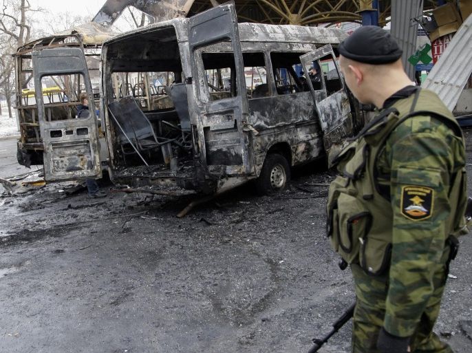 Pro-Russian rebels walk past damaged buses at a bus station in Donetsk, Ukraine, 11 February 2015. Eastern Ukraine was ravaged by fresh fighting, as leaders of France, Germany, Russia and Ukraine geared up for a summit to discuss a new peace plan.