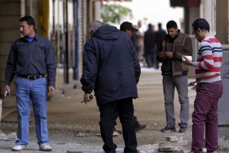 Egyptian security officials inspect the site of explosion, in Cairo, Egypt, 03 February 2015. Media reports said a bomb exploded in a shopping street in downtown Cairo, damaging some shopfronts but causing no injuries. Cairo has seen a rash of bomb attacks since the ousting of Islamist president Mohammed Morsi in July 2013.